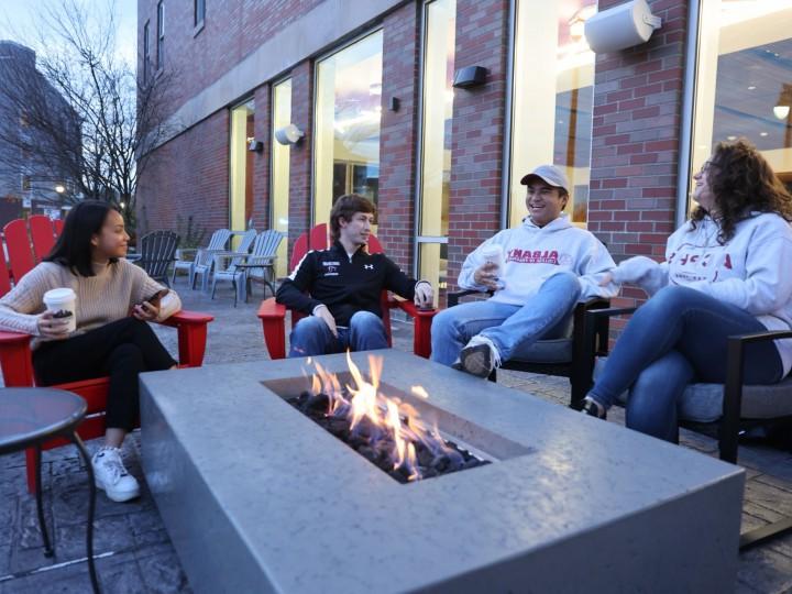 students sitting at fire pit